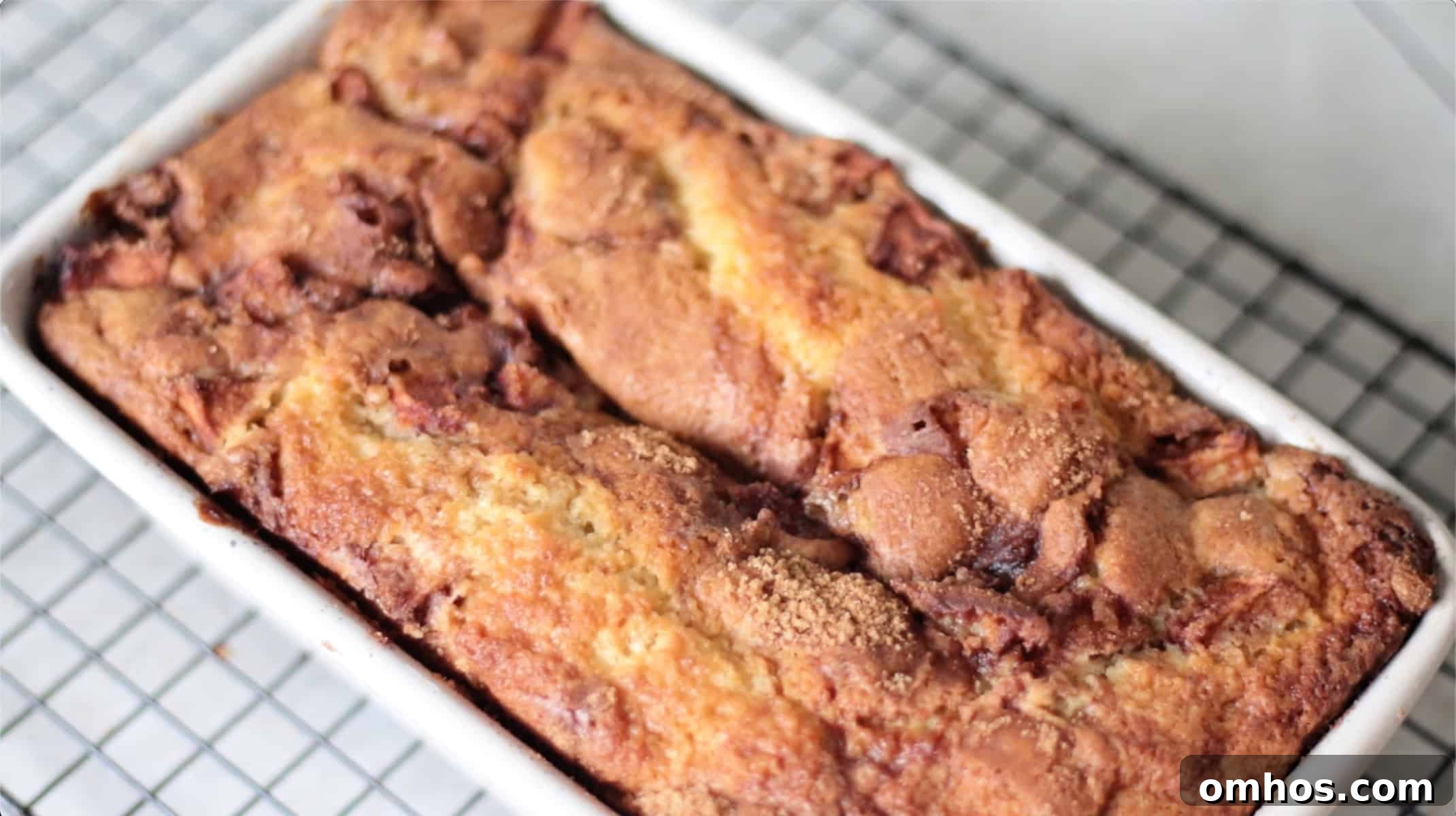 Homemade Apple Fritter Bread with Cinnamon Glaze 9 Apple fritter bread in pan, cooling on rack.