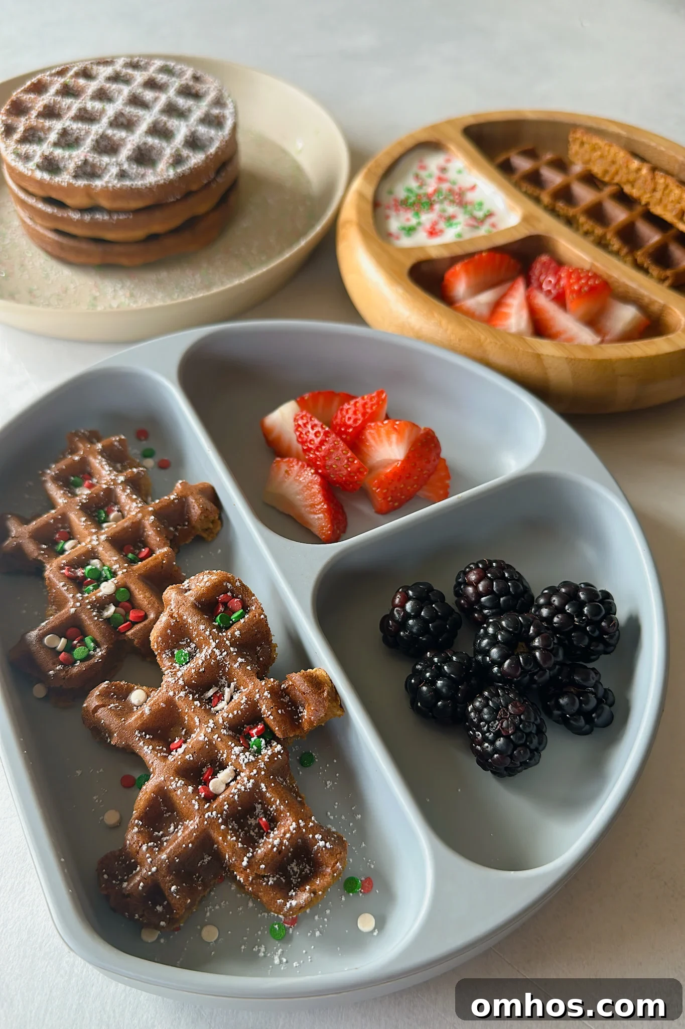 Gingerbread waffles served with yogurt, strawberries and blackberries.