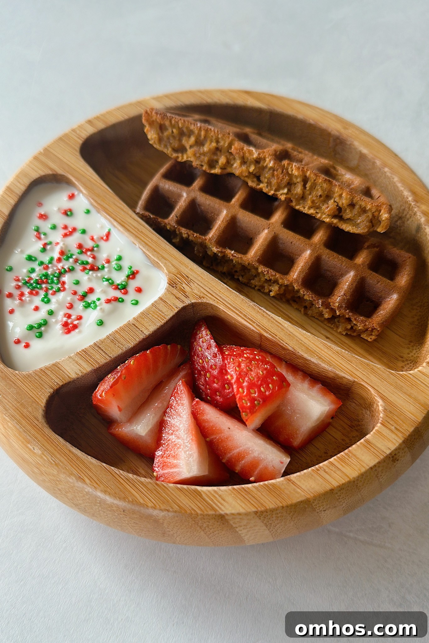 Gingerbread waffles served with yogurt and strawberries.