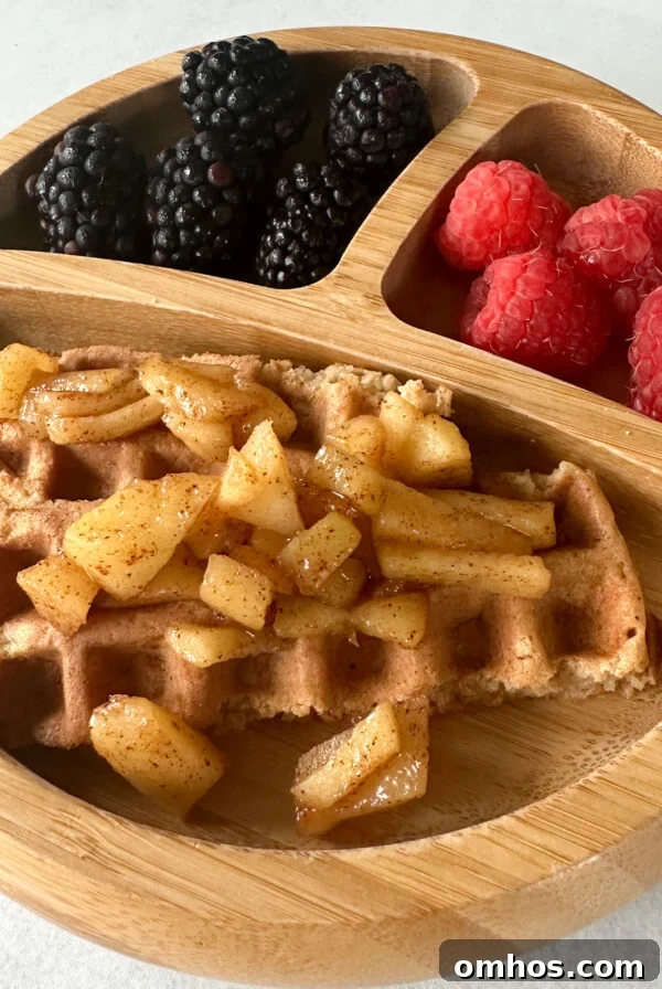 Cinnamon apple waffles topped with cinnamon apples.