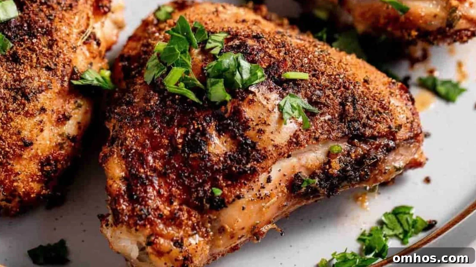 Air fryer chicken thighs crisped golden with visible seasoning across the skin.