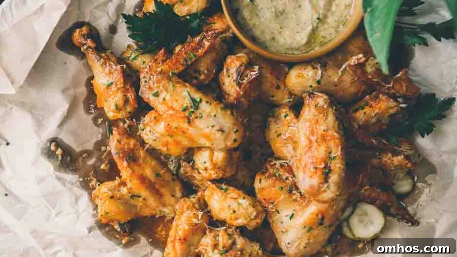Air fryer garlic parmesan wings crisp with cheese and garlic coating.