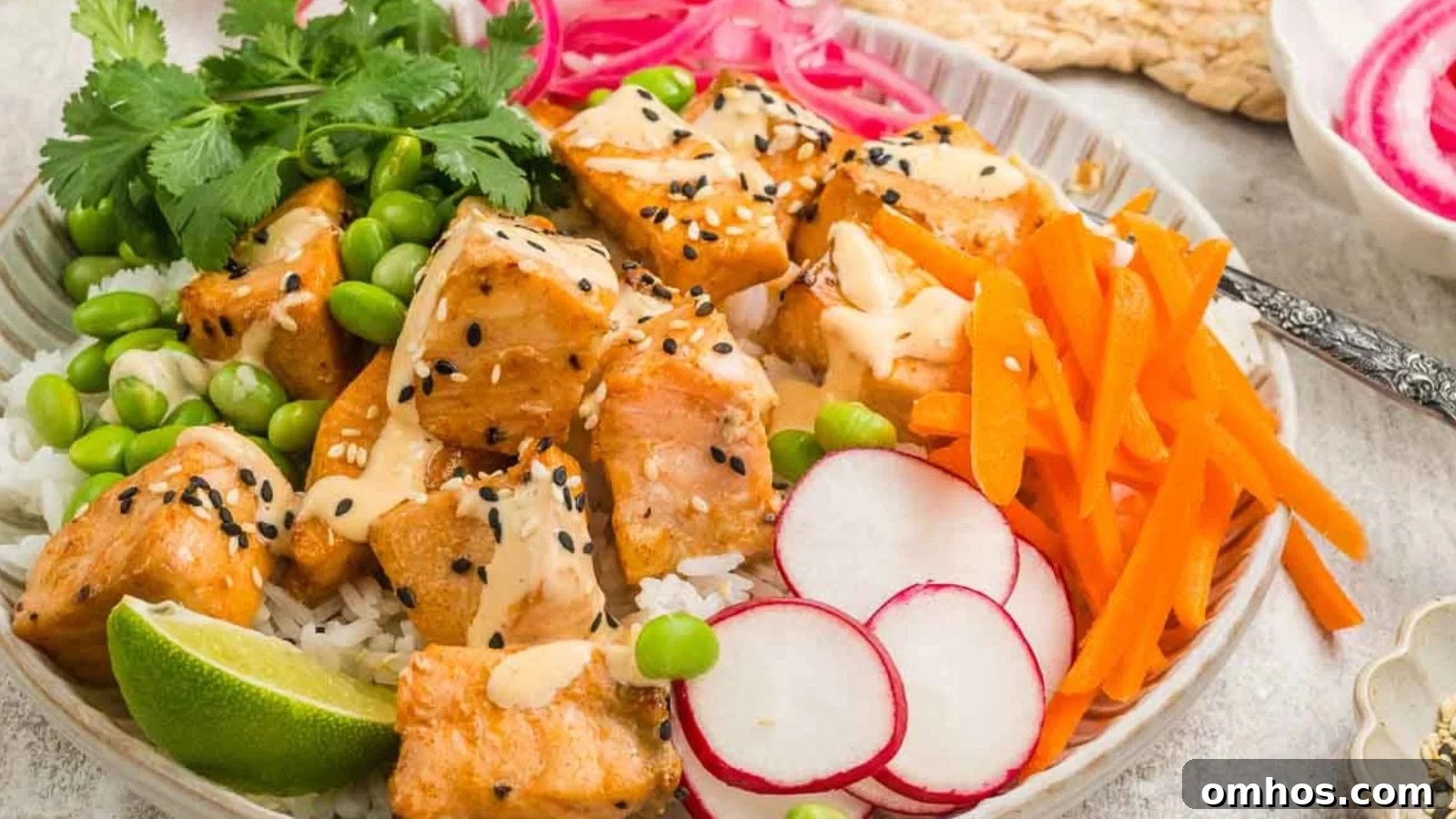 Air fryer salmon bites with crispy edges served with sriracha-lime dipping sauce.