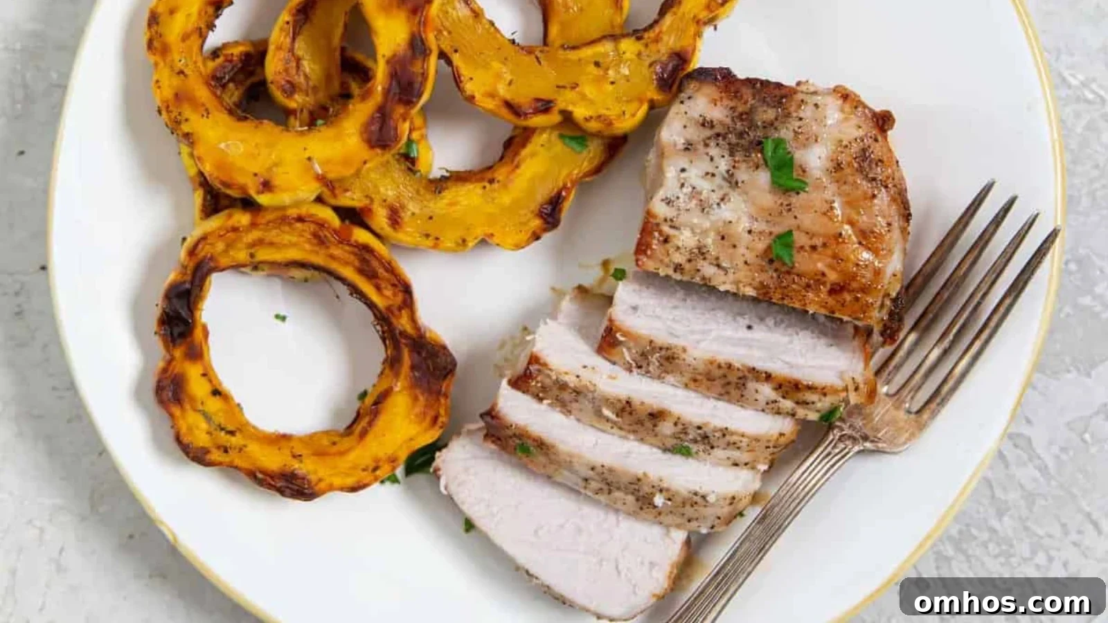 Thick air fryer pork chops golden brown sliced to show juicy center.