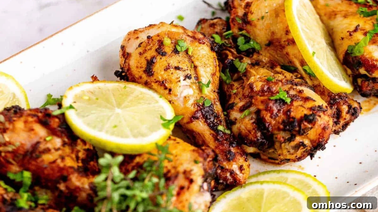 Air fryer chicken legs with browned skin arranged neatly for serving.