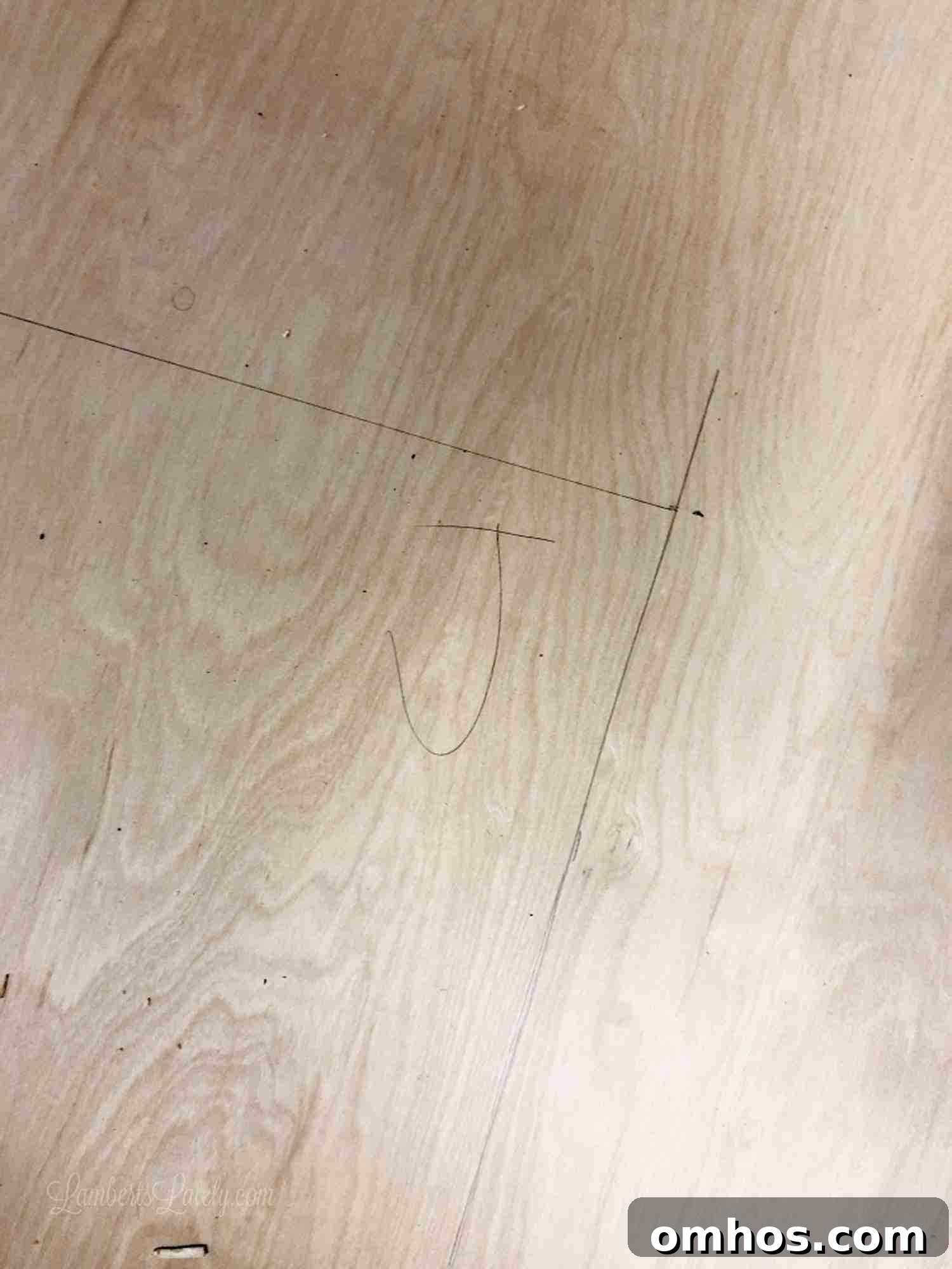 DIY Murphy Bed with Built-In Desk and IKEA Bookcases 5 90 degree angle penciled on a piece of wood, marked with a J.