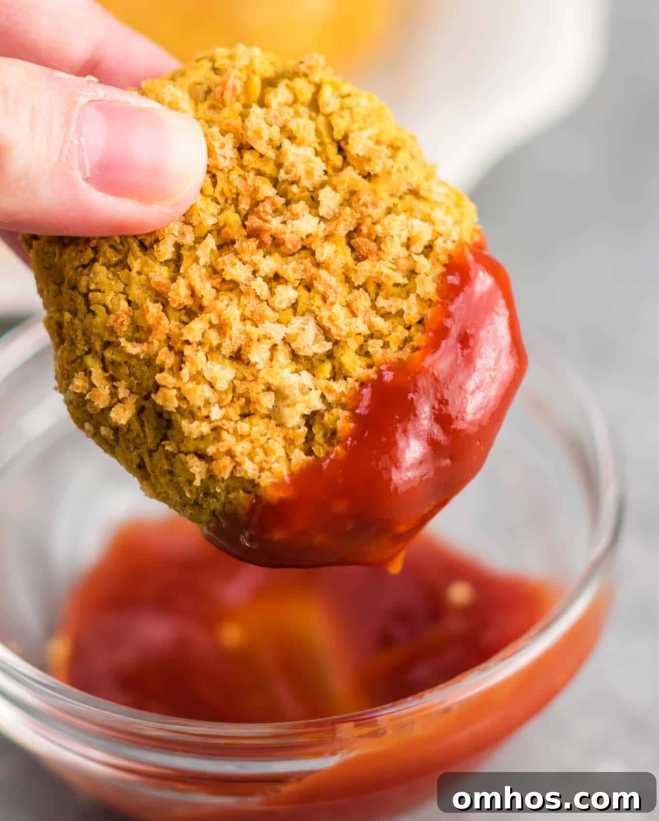 vegetarian chickpea nugget being dipped in ketchup