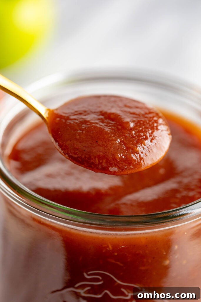 No-Peel Instant Pot Apple Butter Recipe 11 spoonful of apple butter scooped from jar