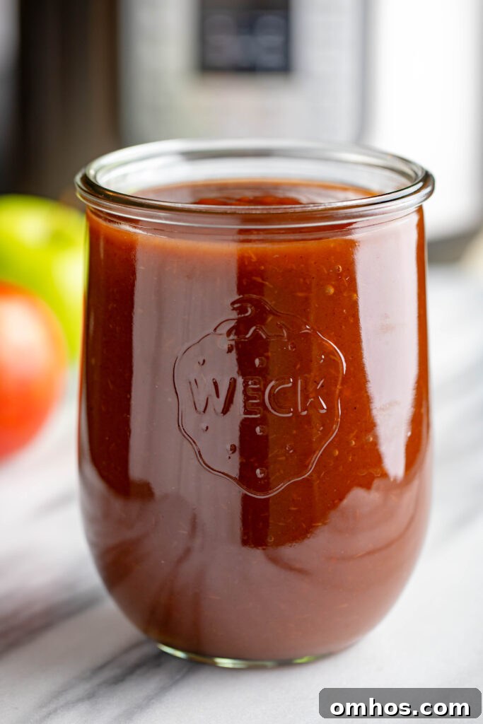 No-Peel Instant Pot Apple Butter Recipe 10 weck jar filled with apple butter made in an instapot