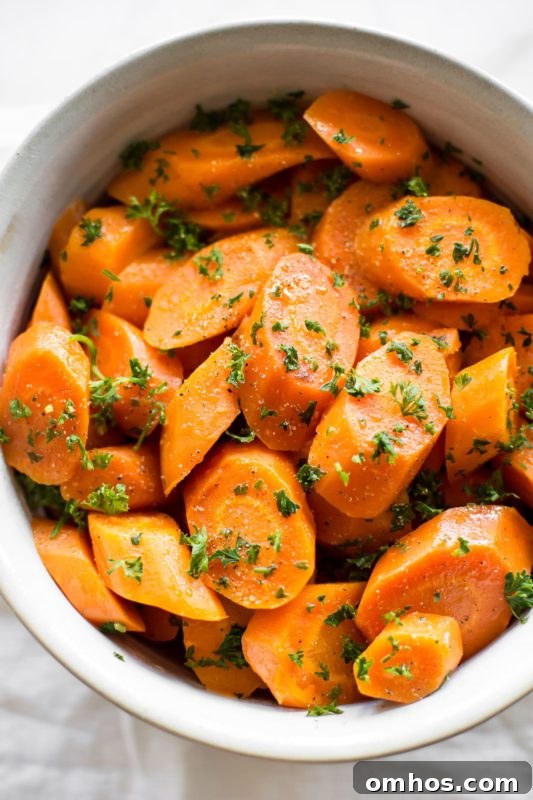 25 Quick Instant Pot Side Dish Recipes for Weeknights 13 White bowl containing carrots, topped with parsley.