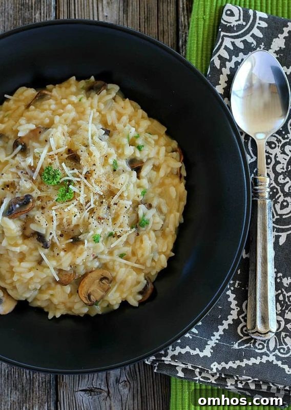 25 Quick Instant Pot Side Dish Recipes for Weeknights 18 Mushroom risotto in a black bowl topped with mushrooms, scallions and Parmesan cheese, spoon on table.