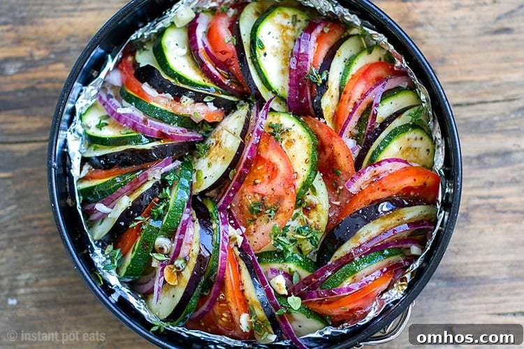 25 Quick Instant Pot Side Dish Recipes for Weeknights 20 Black Instant Pot Pan containing Ratatouille with tomatoes, zucchini, eggplant, bell peppers, onion, garlic, thyme, basil and marjoram.