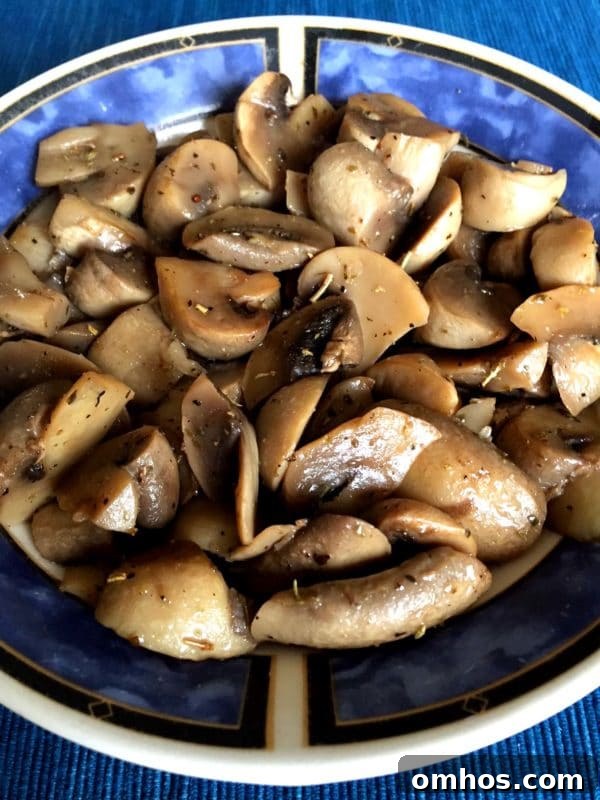 25 Quick Instant Pot Side Dish Recipes for Weeknights 24 Blue bowl containing sauteed mushrooms cooked in an Instant Pot topped with fresh ground pepper.