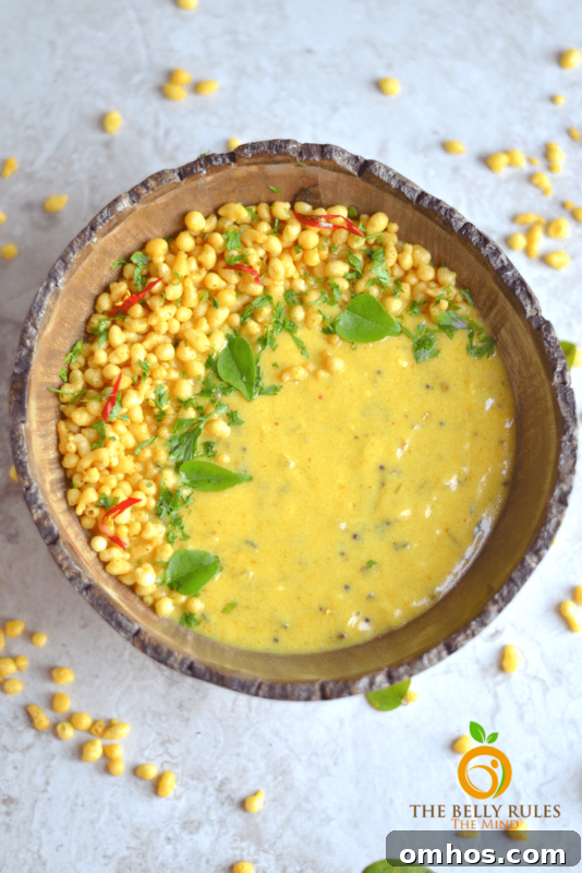 25 Quick Instant Pot Side Dish Recipes for Weeknights 25 Brown bowl containing Punjabi Kadhi Pakoda, kernels of corn on table.