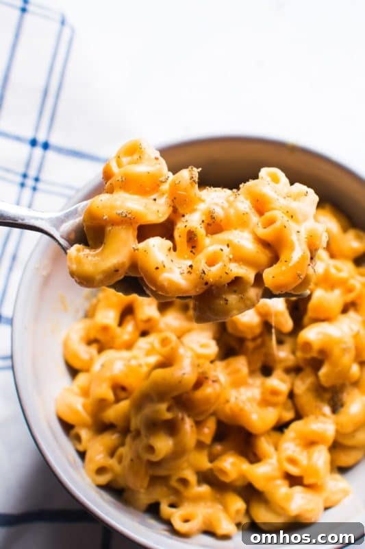 25 Quick Instant Pot Side Dish Recipes for Weeknights 3 Bowl containing macaroni and cheese, fork in the bowl.