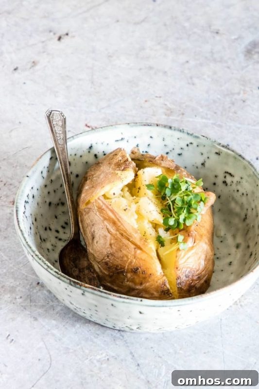25 Quick Instant Pot Side Dish Recipes for Weeknights 4 Baked Potato cooked in an Instant Pot sitting in a bowl on a white counter.