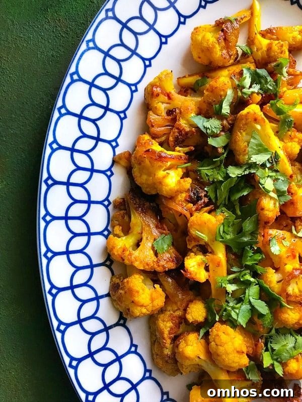25 Quick Instant Pot Side Dish Recipes for Weeknights 6 Blue and white plate containing Cauliflower mixed with Indian Spices made in an Instant Pot.