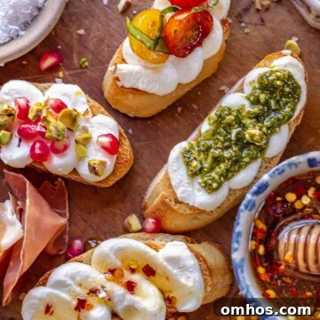 An arrangement of whipped ricotta crostini on a board with fixings.