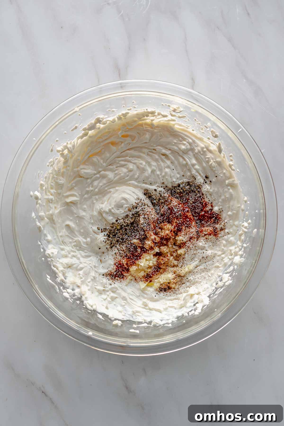 Spice and garlic sit on top of creamed wet ingredients.