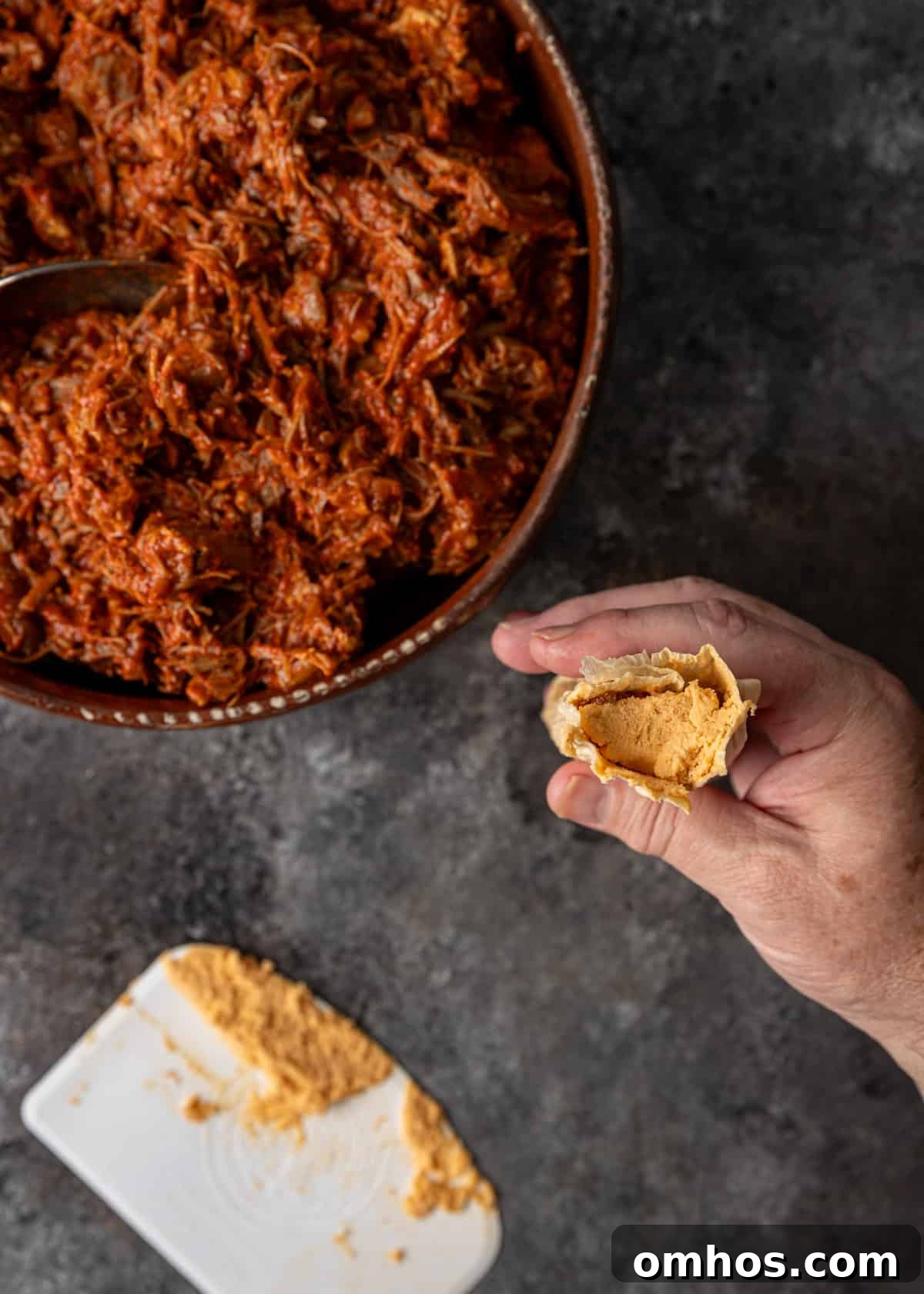 Authentic Mexican Red Pork Tamales Recipe 12 overhead process shot: titled image (and shown) top with masa if you like