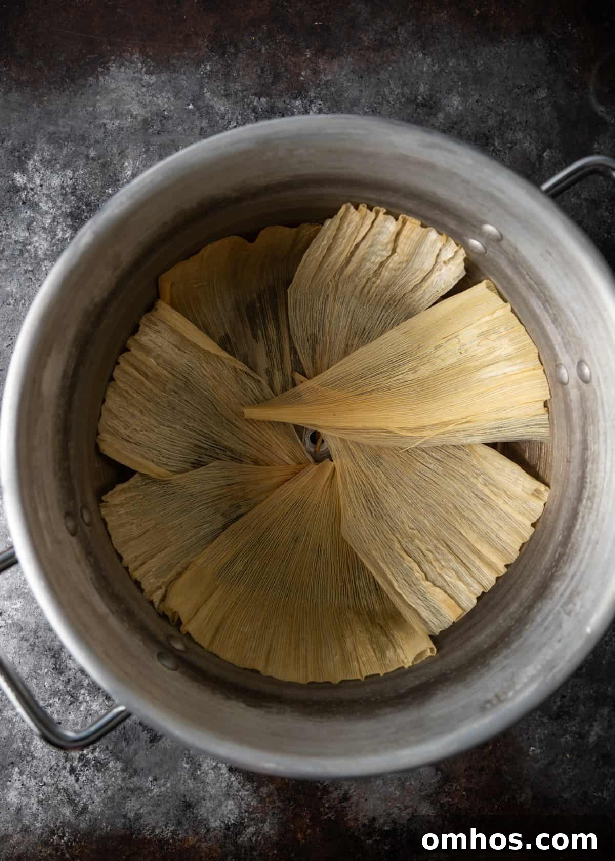 Authentic Mexican Red Pork Tamales Recipe 16 overhead process shot: titled image (and shown) load the tamales to steam