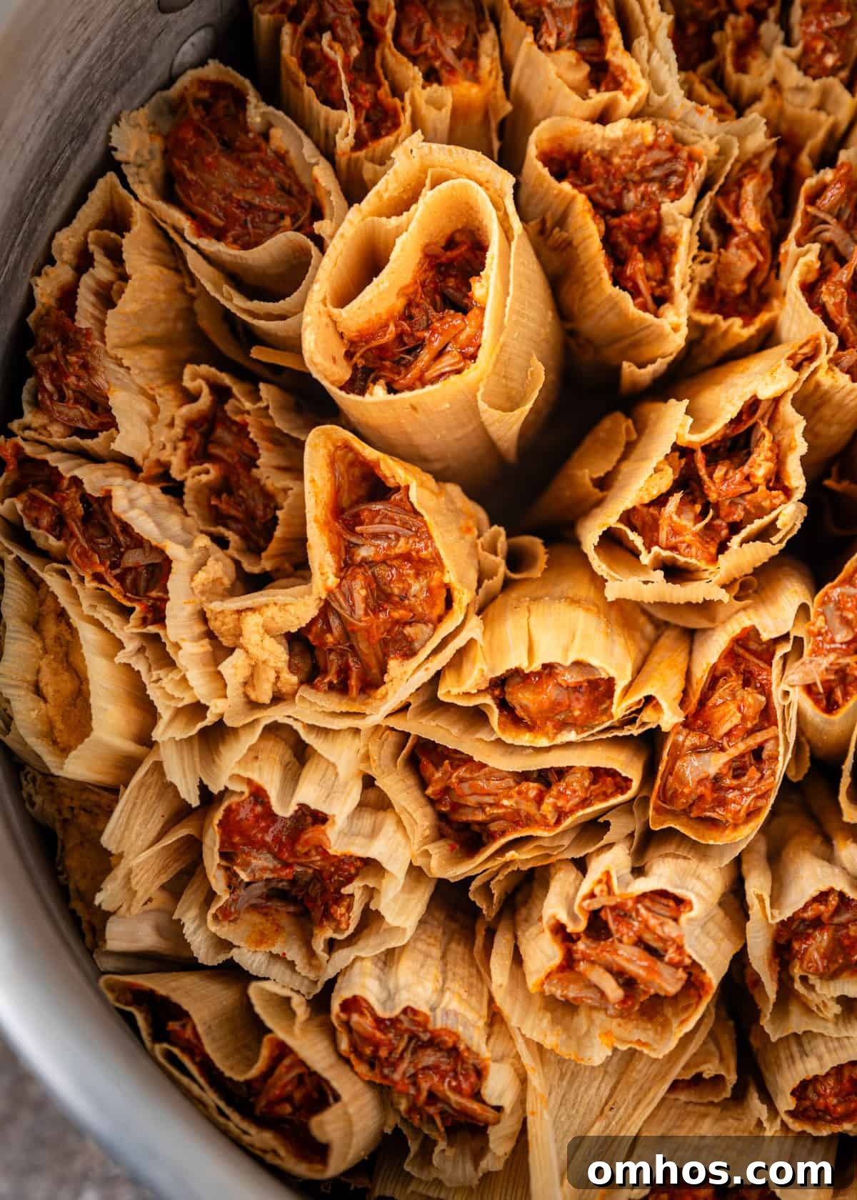 Authentic Mexican Red Pork Tamales Recipe 18 overhead closeup: tamales rojo in a steamer