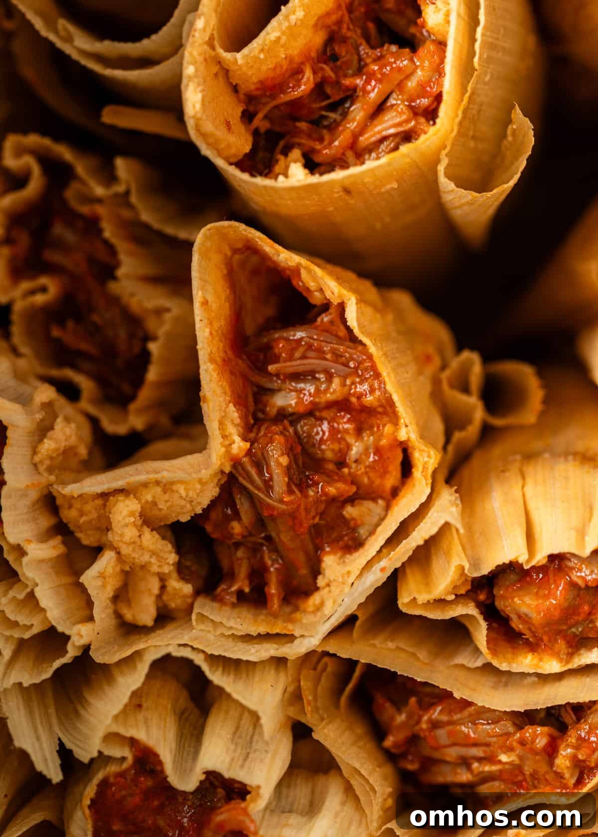 Authentic Mexican Red Pork Tamales Recipe 2 extreme closeup side view: tamales rojo with red filling showing