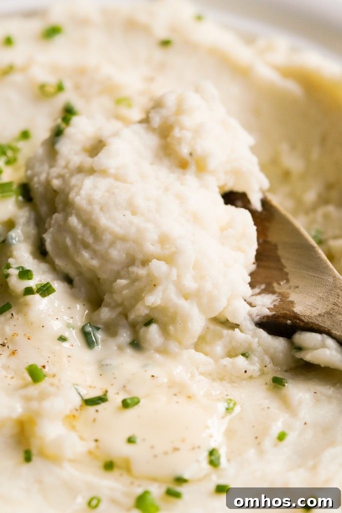 close up shot of wooden spoon scooping mashed potatoes